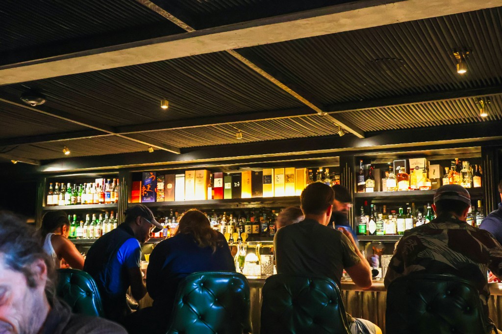 Cocktail bar with bottles on shelves