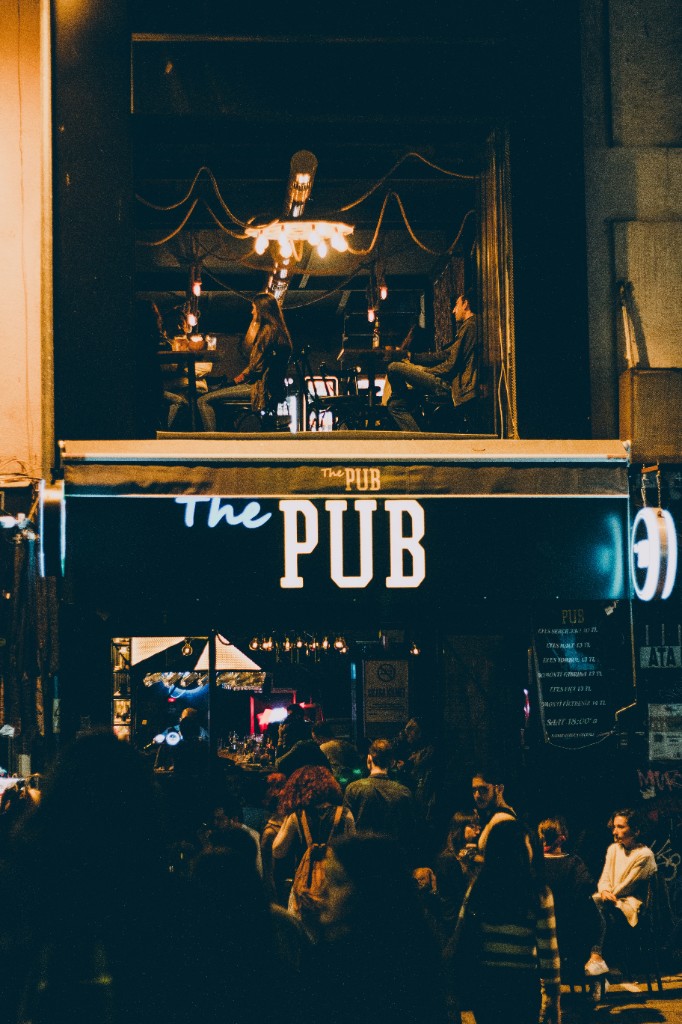 Pub exterior at night with neon sign